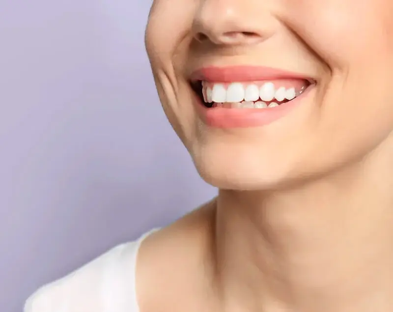Smiling woman showcasing a bright, confident smile, highlighting cosmetic dentistry benefits at Pure Smile Dentistry in North Wales, PA.
