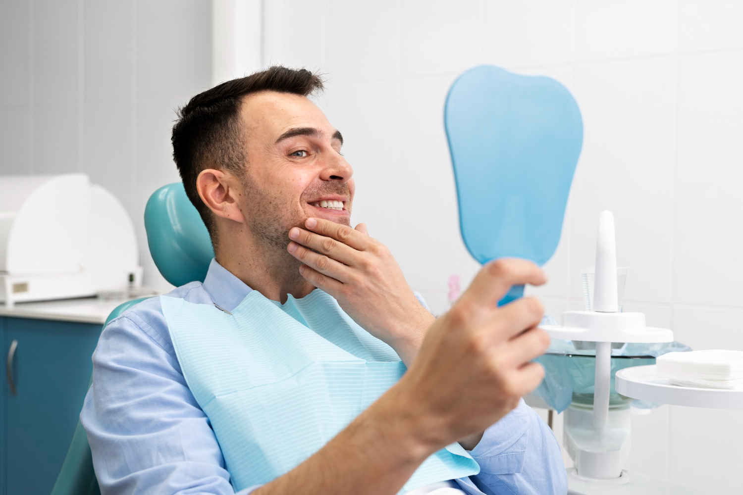 Patient checking teeth in a dental clinic after root canal treatment as part of recovery and aftercare in North Wales, PA.