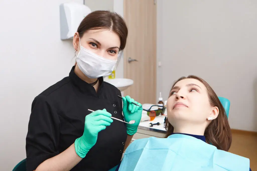 Dentist examining a patient during a dental checkup, showcasing professional dental care and oral health.