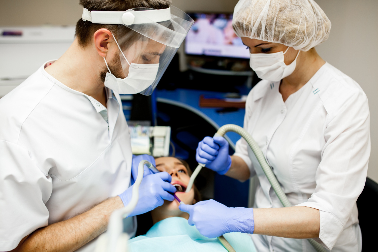 Dentist examining a patient during a root canal treatment procedure in a dental office.