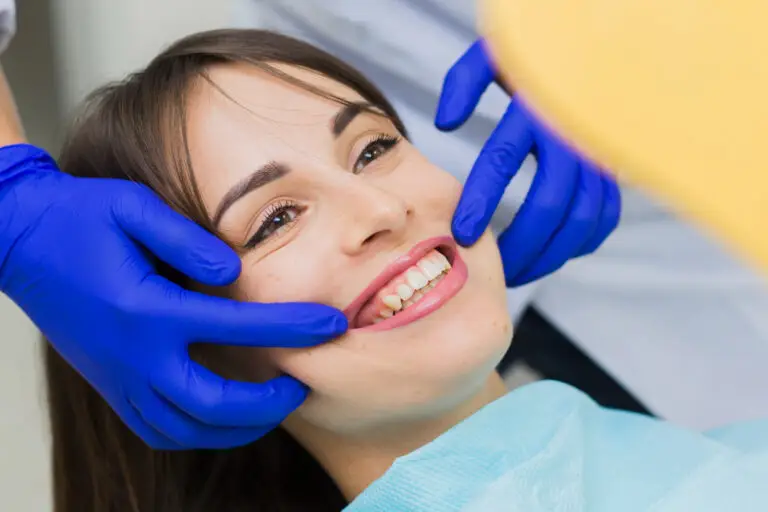Dentist examining a patient’s smile during a cosmetic dentistry consultation in North Wales, PA for a smile makeover.