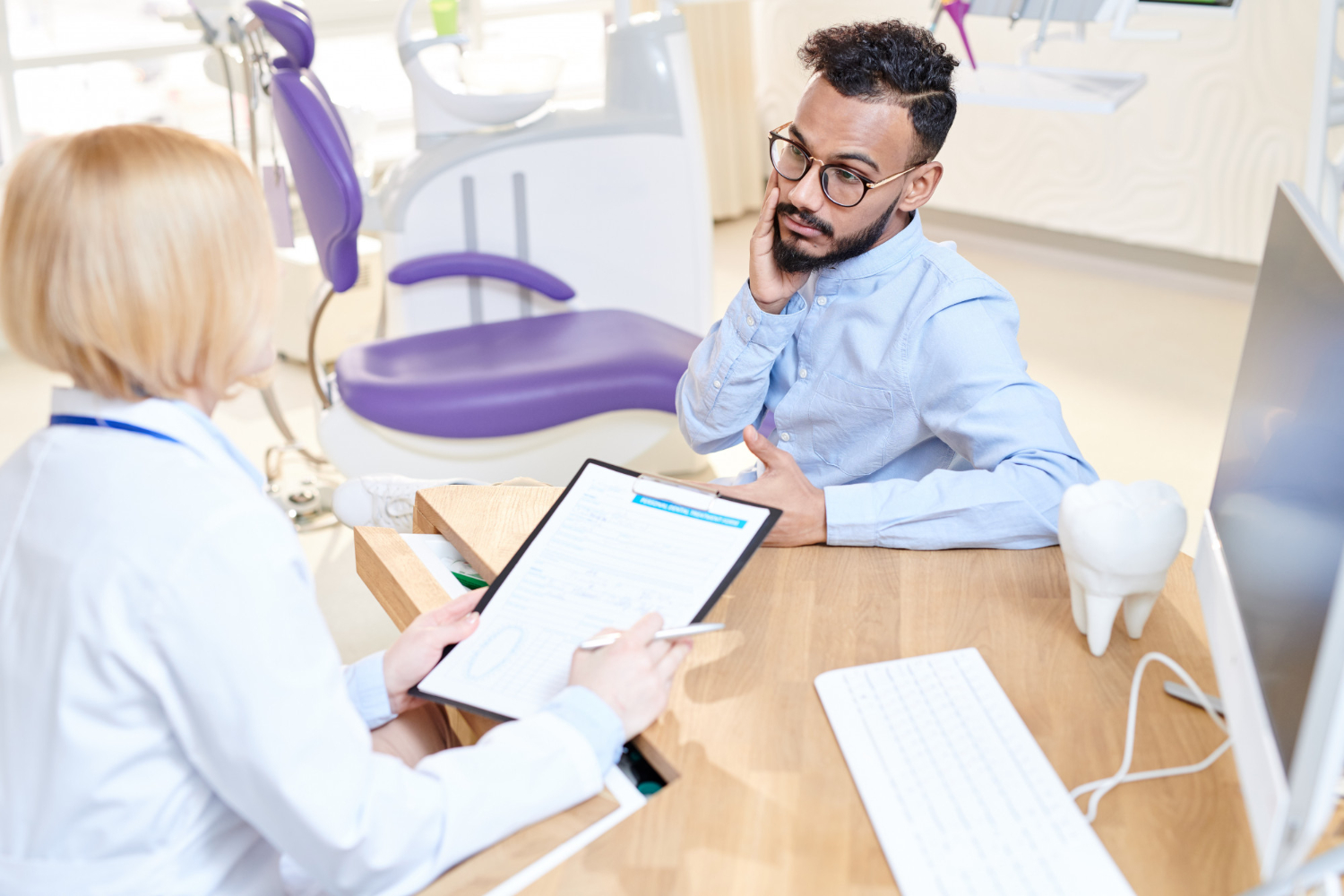 Dental appointment and insurance discussion with a patient at a North Wales PA dental office for care and booking needs.