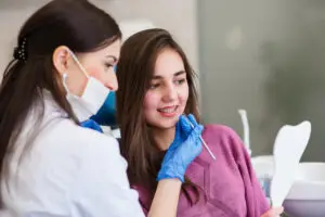 Dentist examining a patient during a cosmetic dentistry consultation in North Wales, PA.