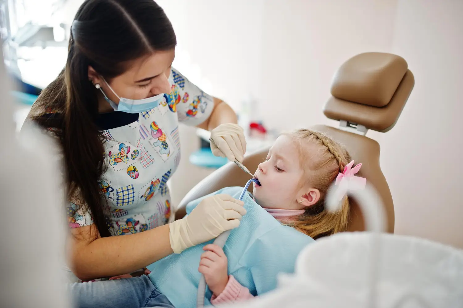 Pediatric dentist providing dental sealants for kids during a preventive dental care visit.