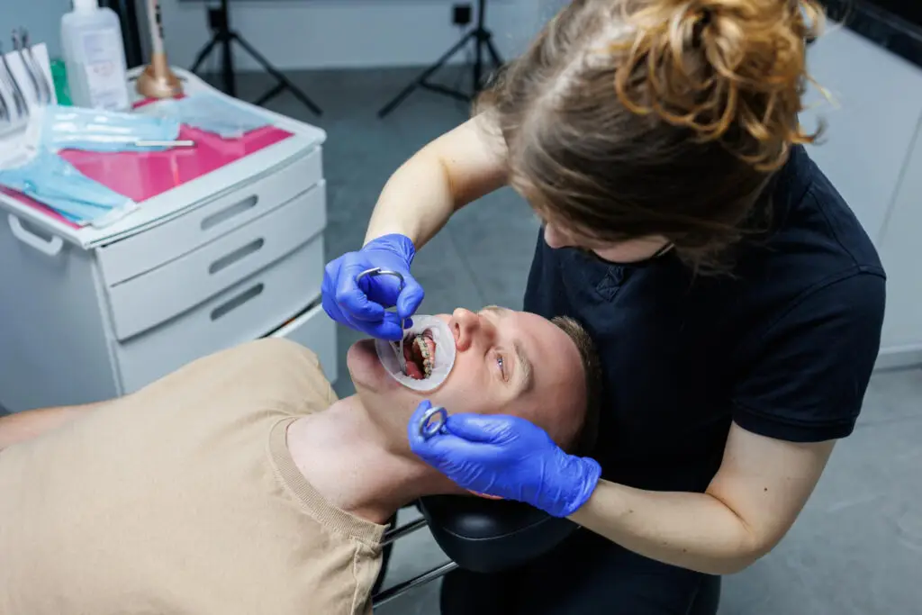 Dentist performing a tooth extraction procedure on a patient during a dental appointment in North Wales, Pennsylvania PA